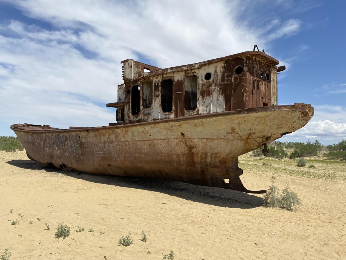 Photo of a boat in a desert.